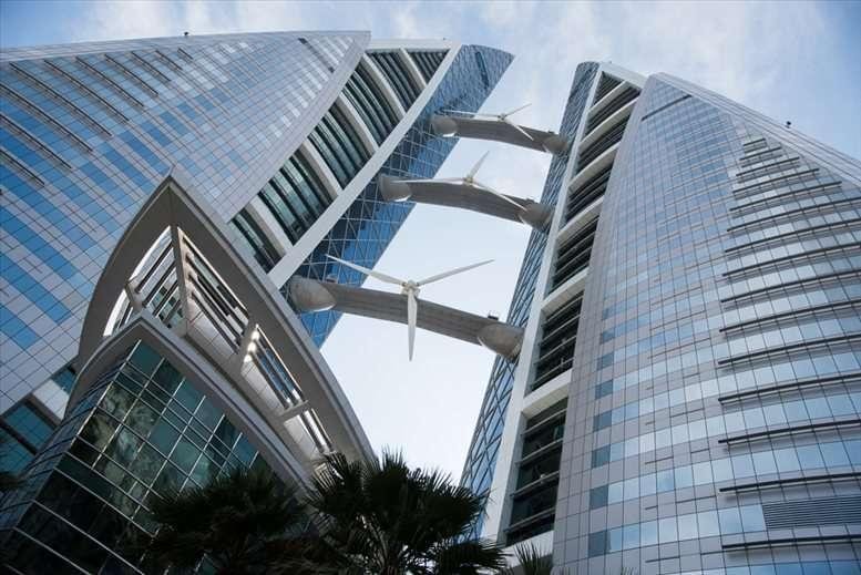 Close-up architectural view of the Bahrain World Trade Centre showing the glass facade and connecting sky bridges.