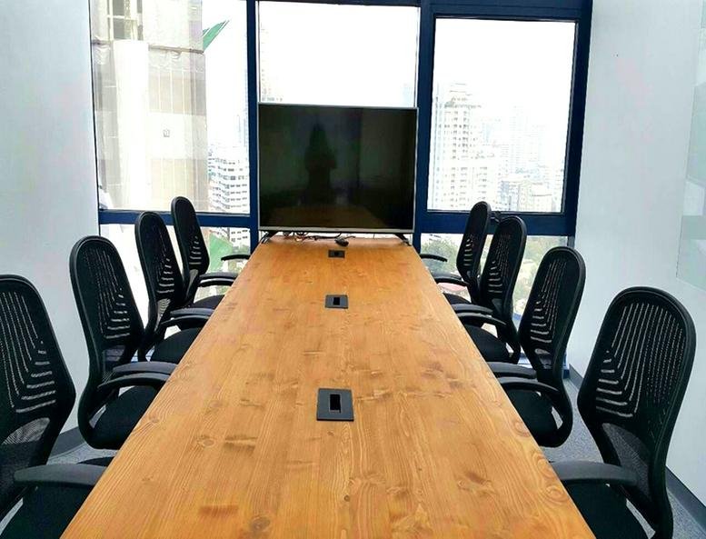 Long wooden conference table in a meeting room at the Glas Haus Building.