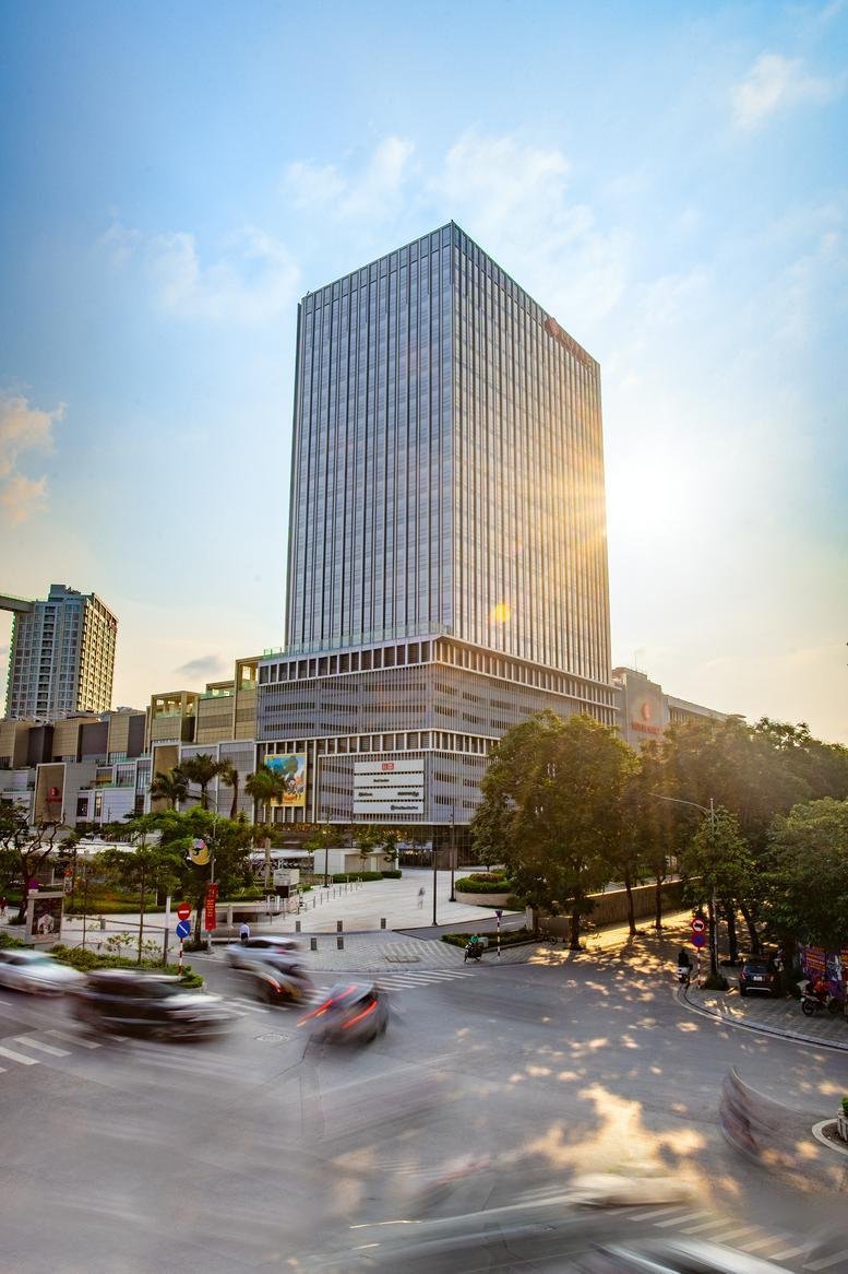 Sunny exterior view of the glass-facade building at Lotte Mall West Lake.