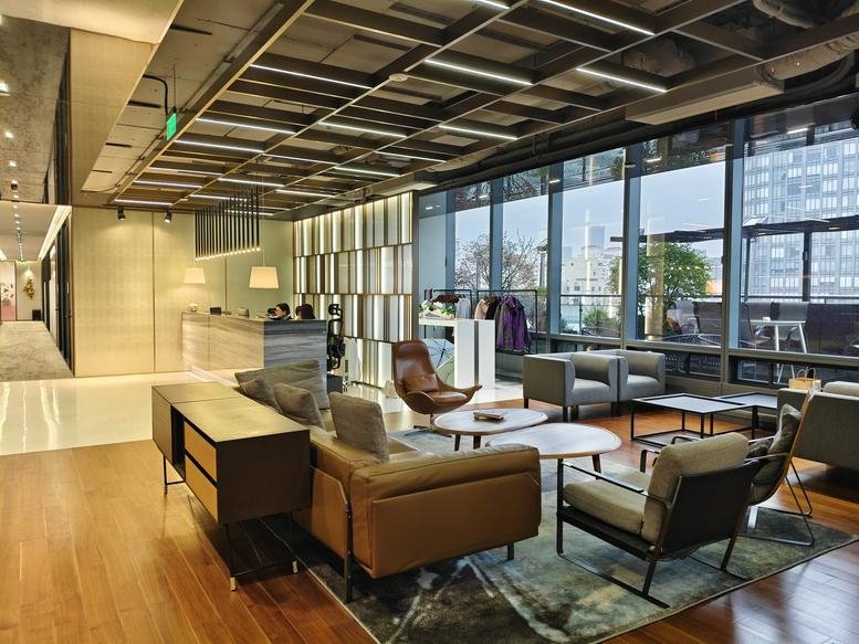 Bright, modern lobby at Lujiazui Financial Plaza with leather seating and high industrial ceilings.