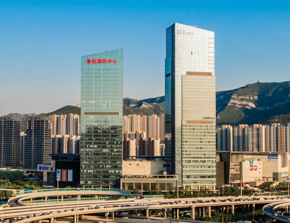 Exterior view of the modern glass-facade skyscrapers at Luneng International Centre.