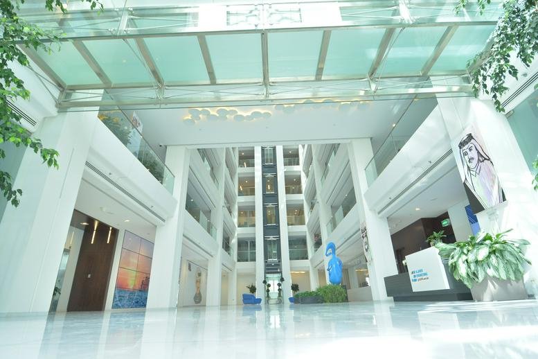 Spacious, glass-roofed lobby of the Lusail City, Fox Hill, Doha, Qatar building with multi-level internal balconies.