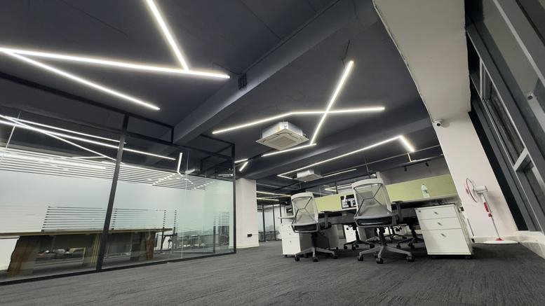 Spacious open-plan workspace at Marrichettu Road, Manikonda, Hyderabad, India with geometric LED ceiling lights.
