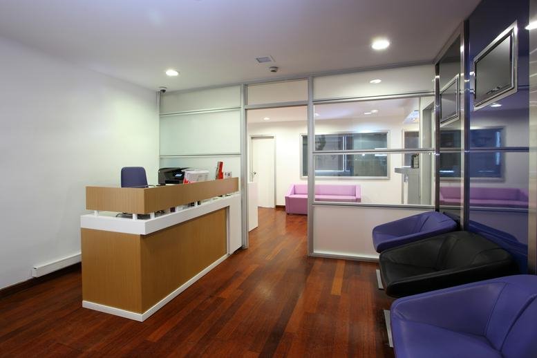 Reception area at Maslak Mahallesi eydan Sokak No 1 with a wooden front desk and purple seating.