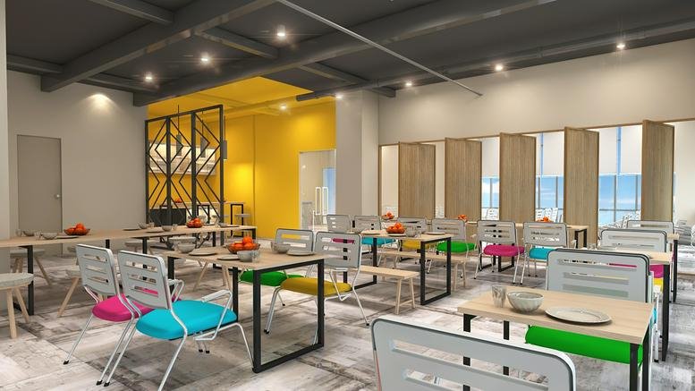 Spacious communal dining area at MATF Building, Gizri Road, Clifton, Karachi with colorful seating.