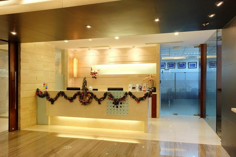 Elegant reception area with a curved desk decorated with a festive garland.