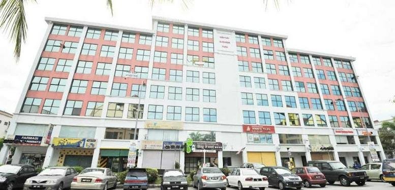 Exterior view of the Mentari Business Park multi-story commercial building with ground floor shops.