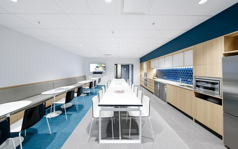 Spacious kitchen and breakout area at Mezzanine Level, Aspley Hypermarket with long communal tables.