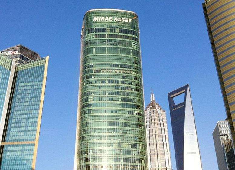 Exterior view of the glass-facade Mirae Asset Tower standing among skyscrapers in Pudong.