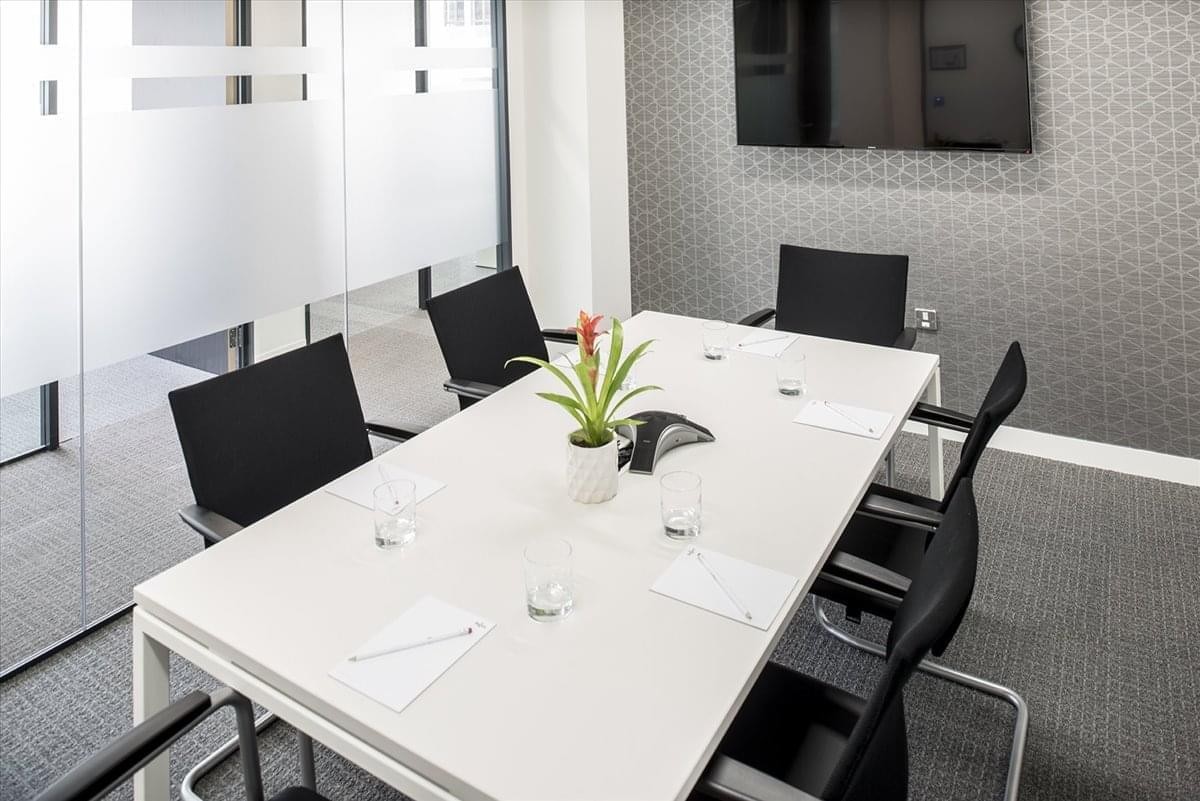 Meeting room with a white table, black chairs, and a potted plant at 4th floor 1-5-11, Nagoya City.