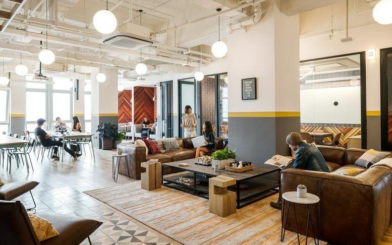 Spacious communal lounge at Nanjing Xi Lu, 819 West Nanjing Road, Shanghai with leather sofas and industrial decor.