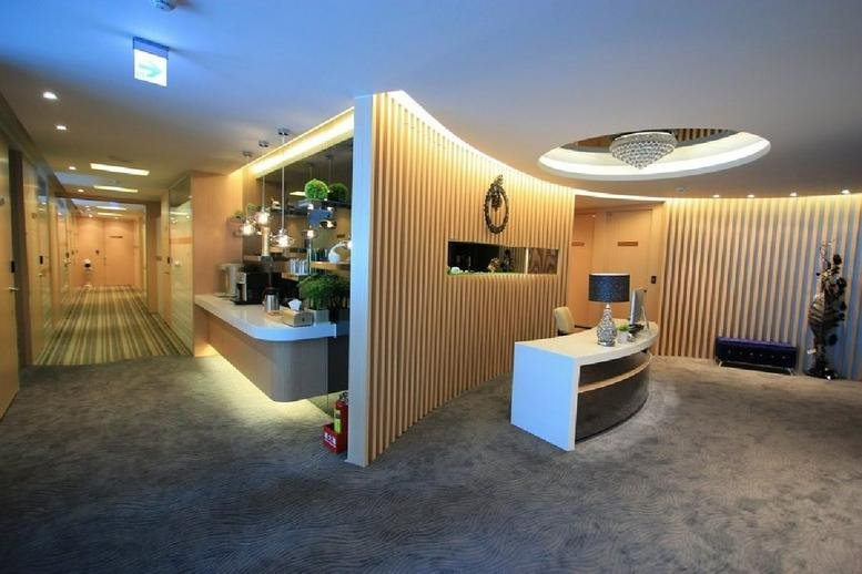 Spacious reception area with a curved wooden feature wall at Nasdaq Center, 607 Ruiguang Road.
