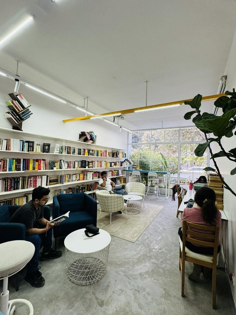 Spacious reading lounge at Odyssey Bungalow with extensive library and modern seating.
