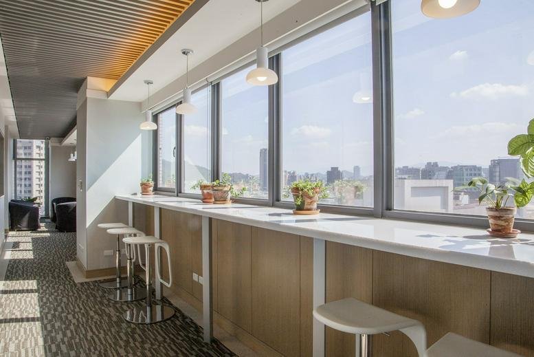 Bright break area with high-top seating along large windows at 10F, No. 66 Section 1 Neihu Road.