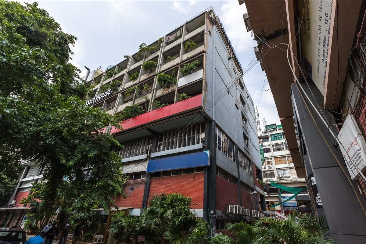 Exterior view of the multistory Punj Essen House building with red and blue facade accents.