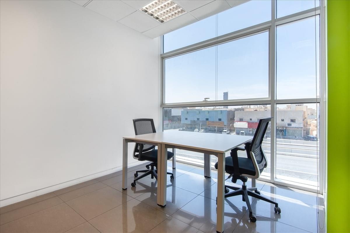 Private two-person office suite featuring large windows and an accent wall at Nimr Al Nakheel centre.