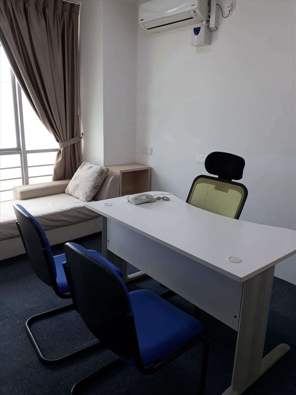 Spacious private office at No31-02 jalan Molek 1/5A with a white desk, blue chairs, and a window-side lounge sofa.
