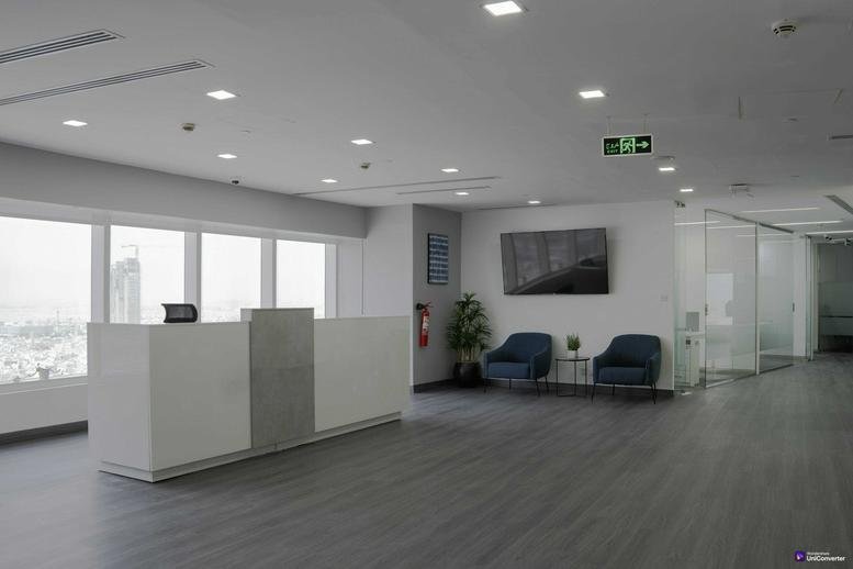 Modern white reception desk at Olaya Street with large windows and a waiting area.