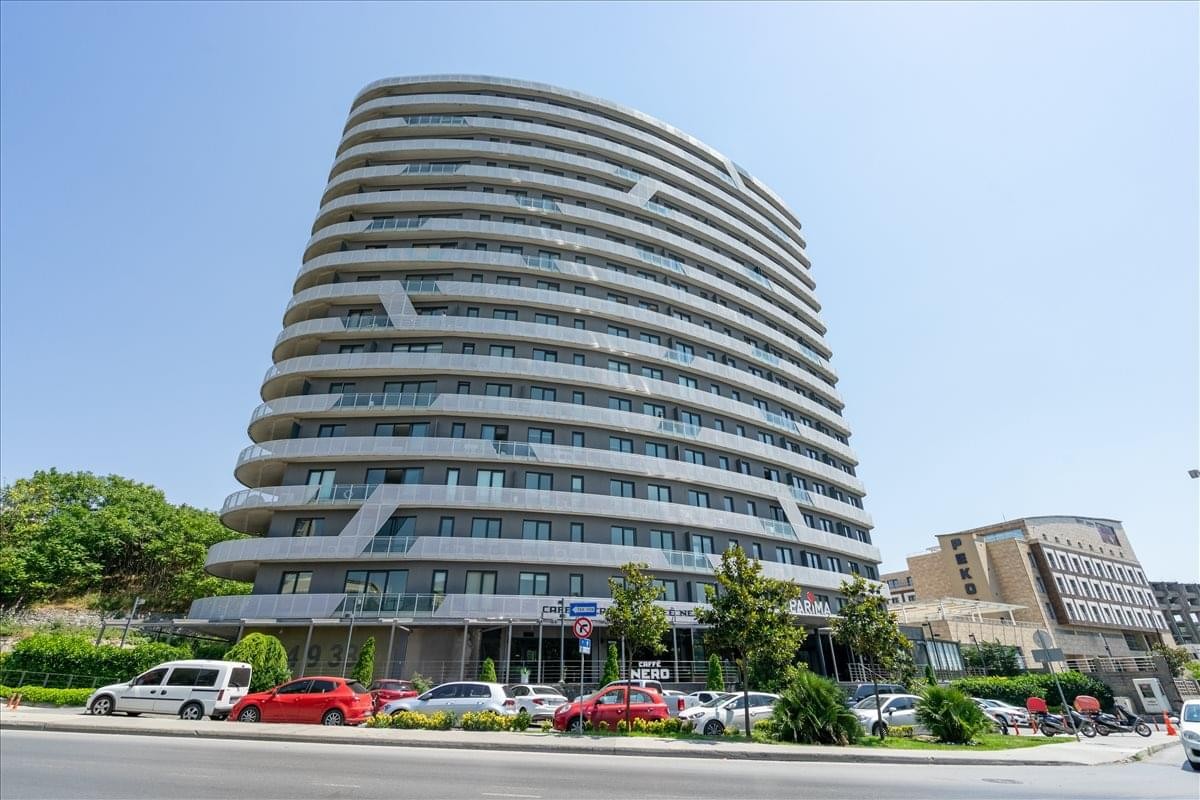 Exterior view of the contemporary curved glass facade at Parima Residence.