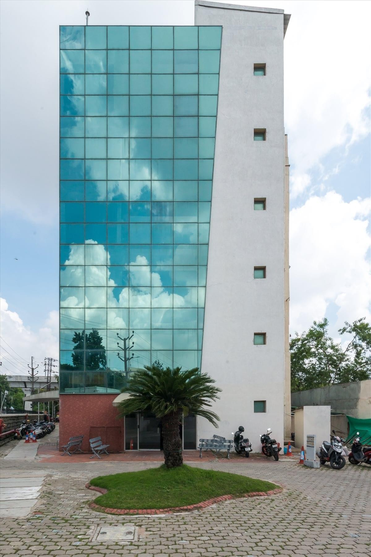Spacious communal bar and lounge area at Phoenix Tech Tower with vibrant blue glass accents.