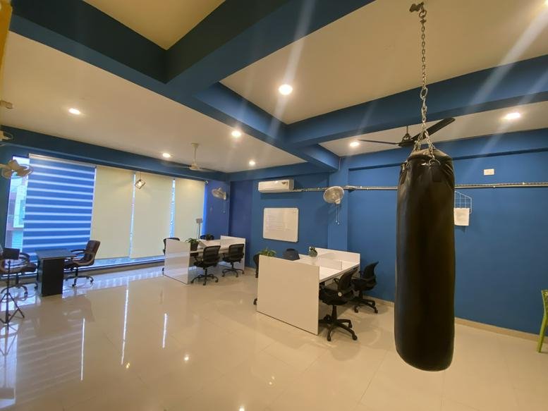 Spacious interior of RF Qubicals, 2nd Floor, Plot no. 23, Kundan Nagar, Bhopal, India with blue walls and a punching bag.