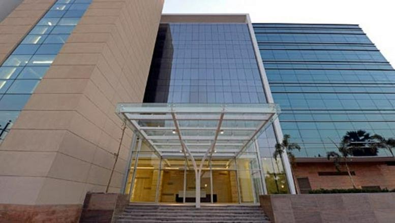 Exterior view of the glass-facade building at Plot No. D-3, Road Number 16, Wagle Industrial Estate.