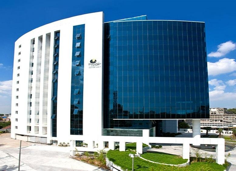Exterior view of the modern glass and white facade of Prestige Palladium Bayan.