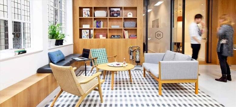 Spacious communal lounge at Prestige Shantiniketan, Crescent 4, Level 2, with wooden bookshelves and a patterned rug.