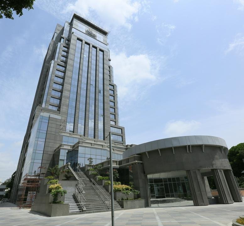 Exterior view of the modern glass facade of the Prestige Trade Tower in Bangalore.