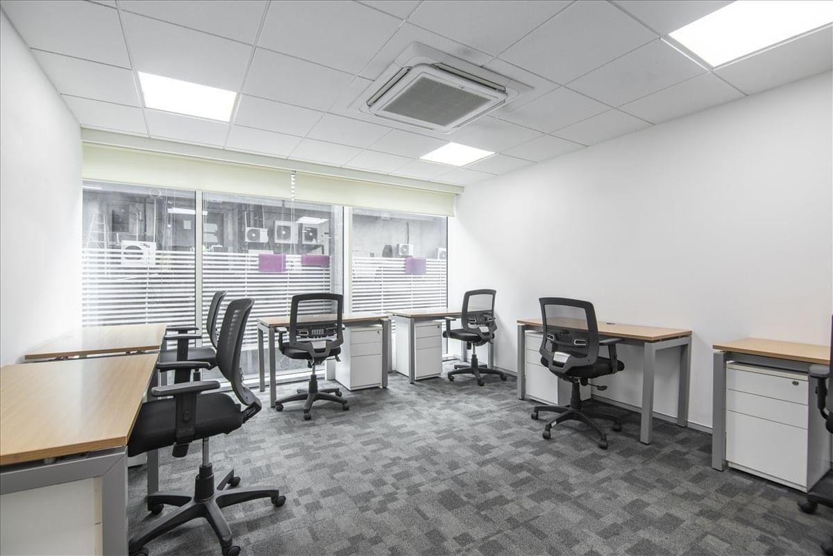 Spacious open-plan workspace at Sky One, Prathamesh Society, with multiple workstations and natural light.