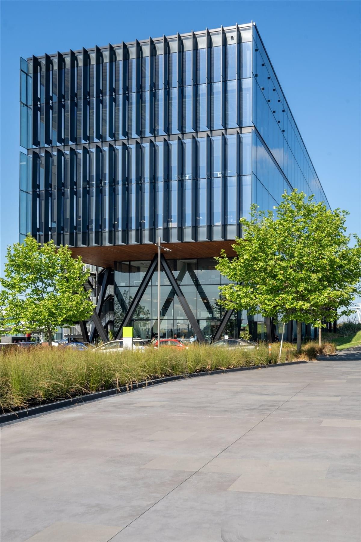 Exterior view of the glass-facade Quad 7, Auckland Airport building with distinctive black structural braces.