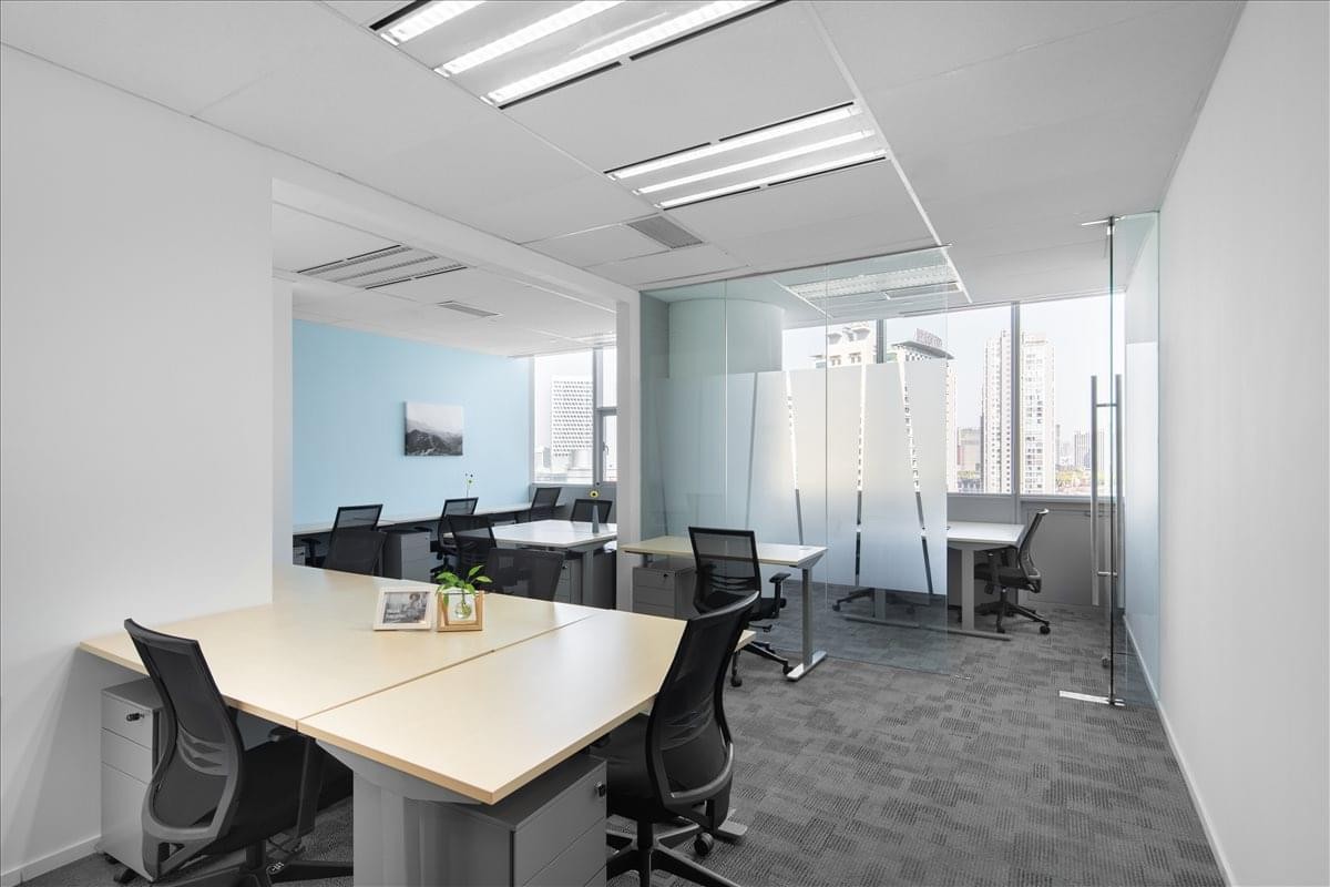 Professional coworking space at Raffles City with modern desks and abundant natural light.