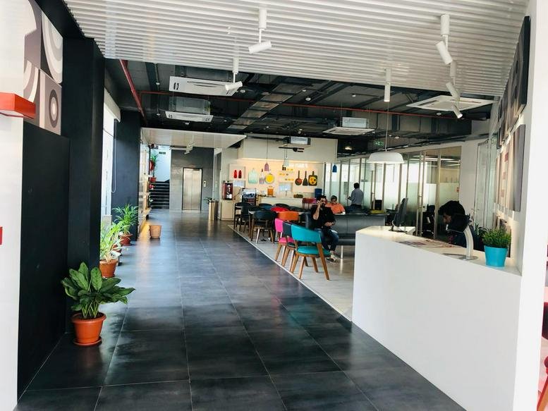 Spacious reception and lounge area at Redbrick House, N. T. R Pride Building with polished dark floors.