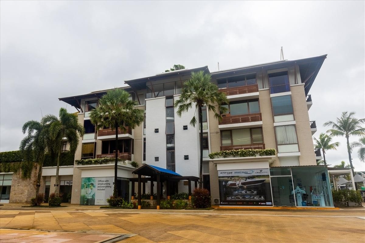 Exterior view of the Regus Royal Phuket Marina Business Centre, Building MC2 with palm trees.