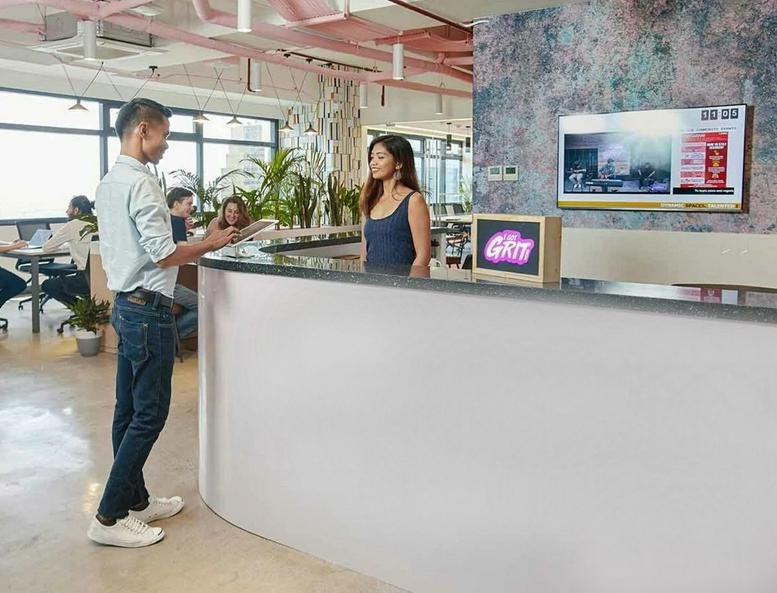 Reception desk at Robinsons Cyberscape Gamma with staff and modern wall art.