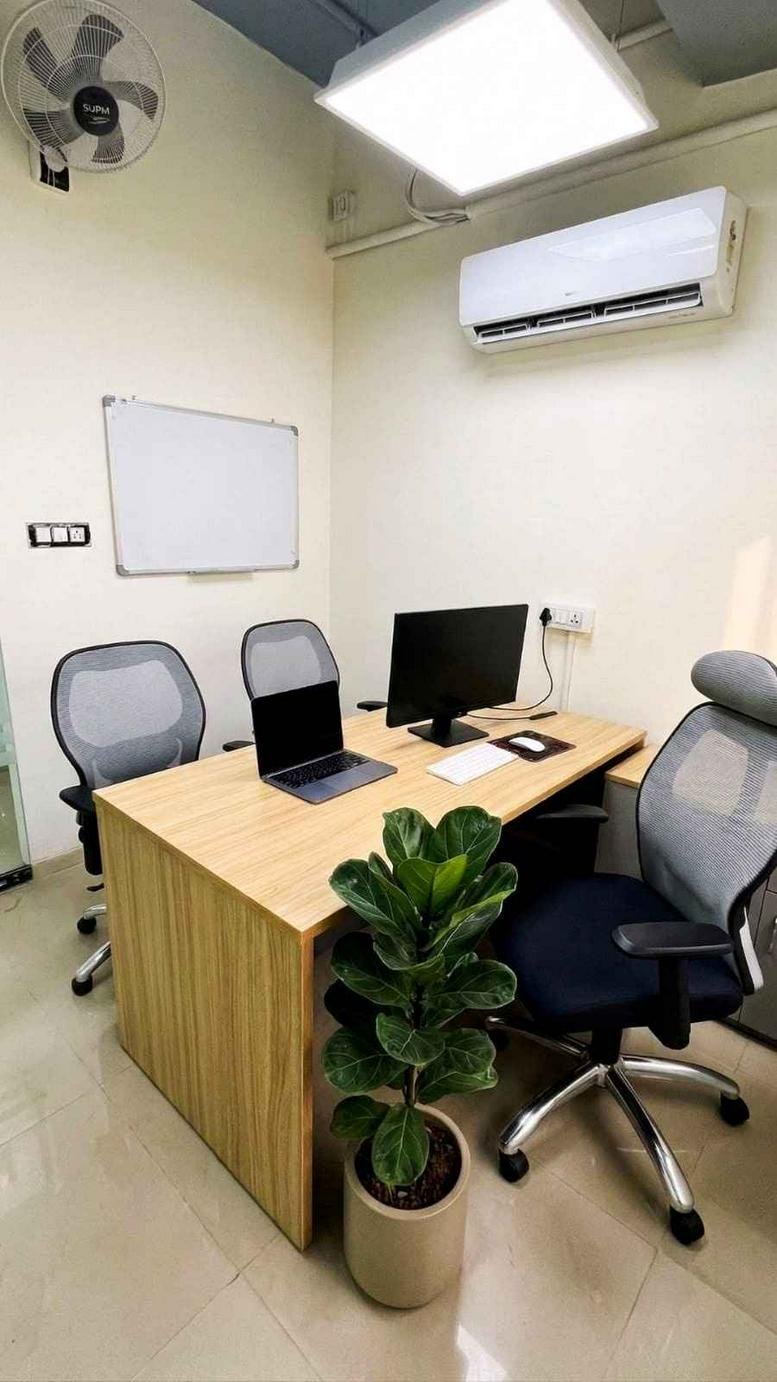 Private office at Rz-4, Dichaon Kalan Road, Najafgarh, West Delhi, India with wooden desk and a potted plant.