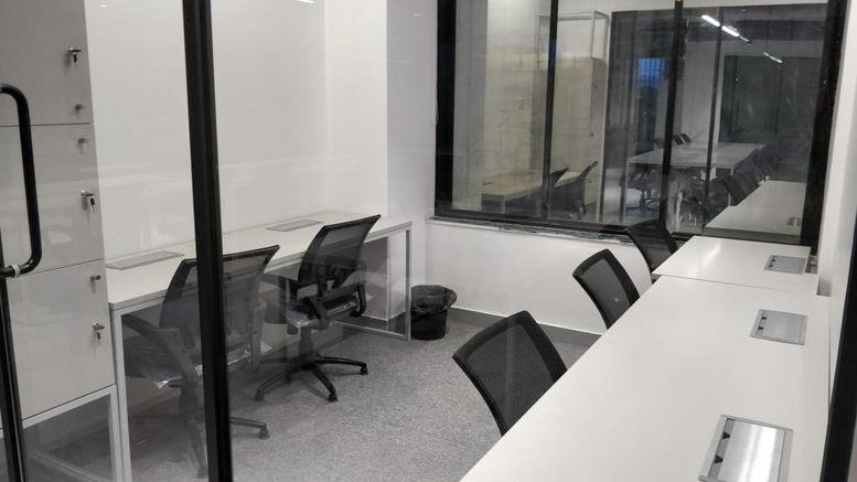 Private office space at Sai Empire Above Poona Republic with four desks and black mesh chairs.