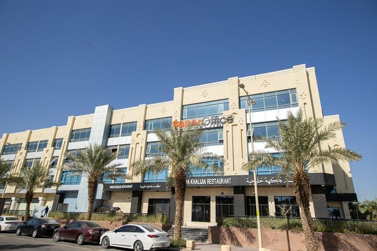 Exterior view of the sand-colored building at Saida, Al-Durayhimiyah, Riyadh 12791 with ground-floor shops.