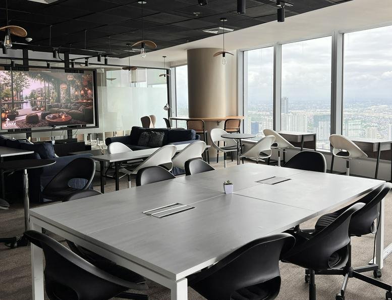 Spacious coworking area at VANTIS, 6795 V. A. Rufino Street with various seating and floor-to-ceiling city views.