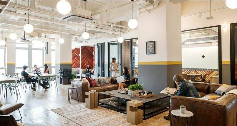 Spacious communal lounge at Jl. Jend. Sudirman No. 52-53, SCBD with leather sofas and industrial ceilings.