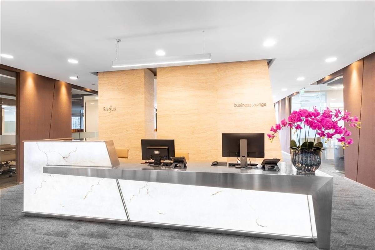 Modern lobby of Tower A, Shengchangcheng Financial Centre with a marble reception desk and pink orchids.