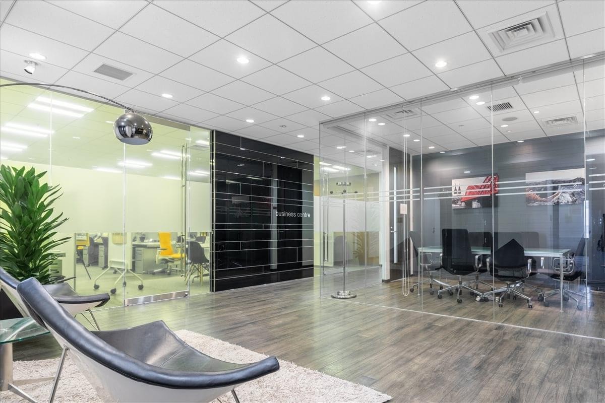 Bright lobby at Sendai Mark One featuring glass-walled meeting rooms and contemporary lounge seating.