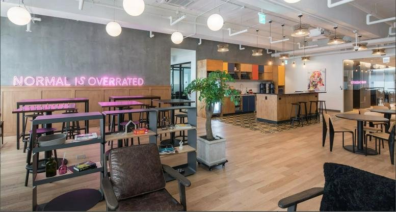 Spacious common area at Seoul Station, 416 Hangang-Daero featuring neon signage and tiered shelving.
