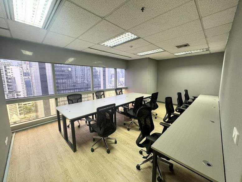 Spacious meeting room at Serm Mit Tower featuring a long white table and city views.