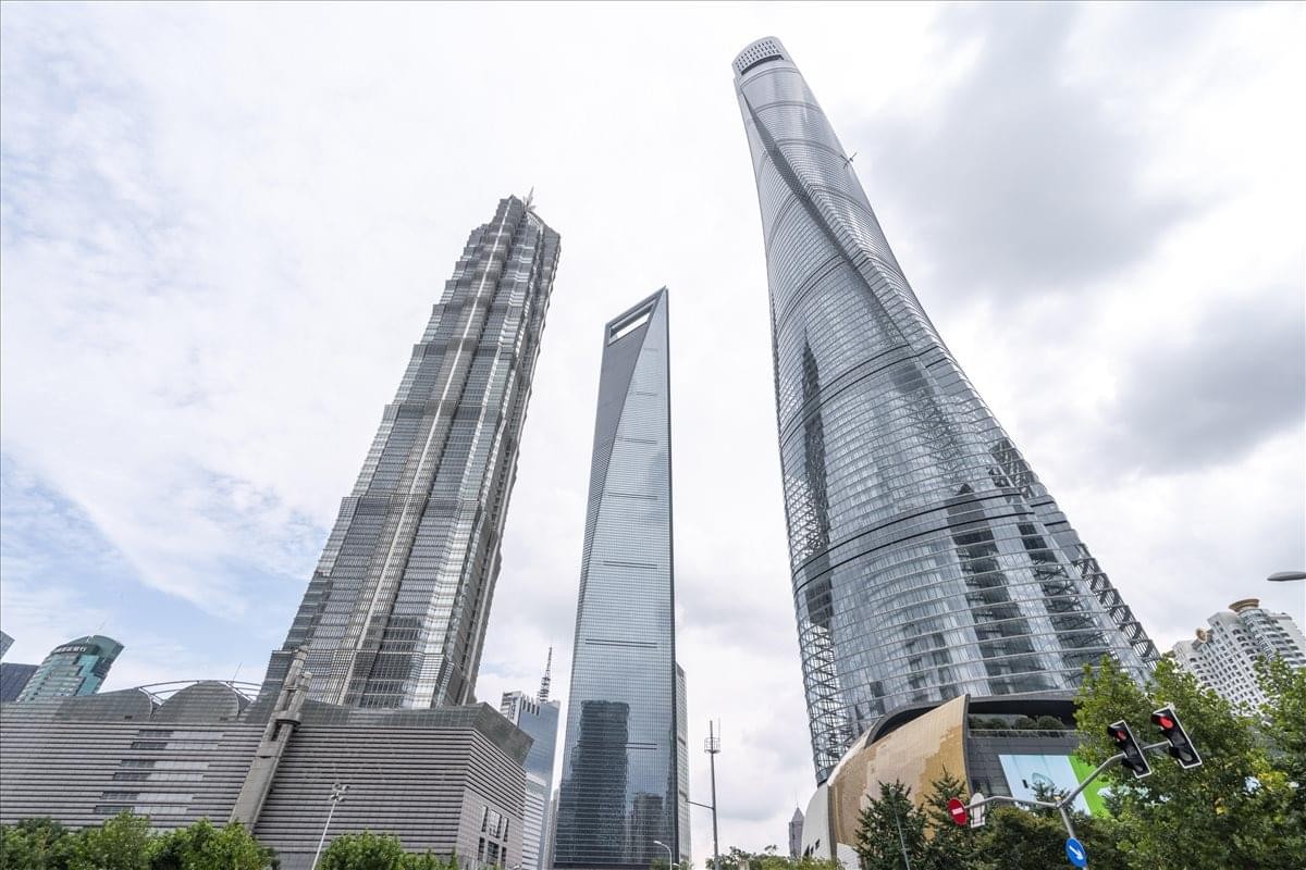 Exterior view of the iconic glass-facade Shanghai Tower rising above the financial district.