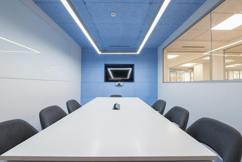 Modern conference room at Shanta Sriram Building, PSR Towers with blue ceiling and recessed lighting.
