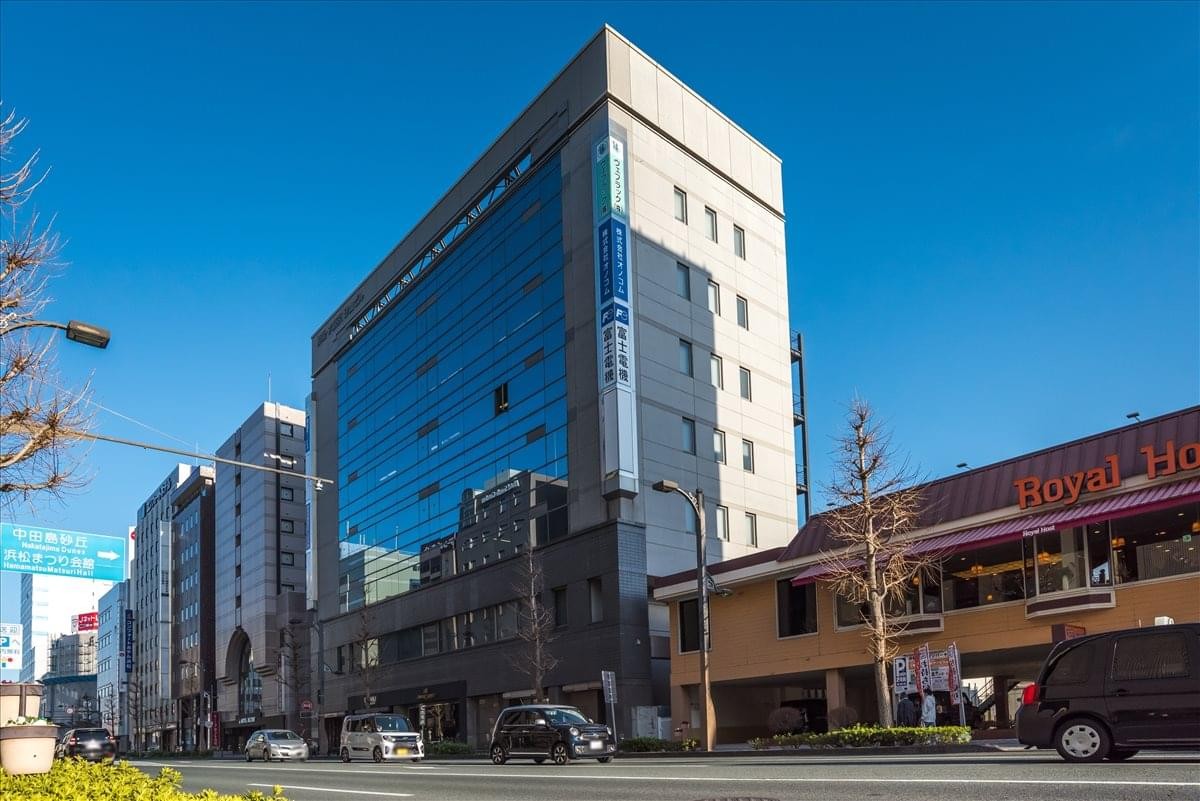 Exterior view of the Shizugin Dai Tokyo Sunayama Building showing its glass and stone facade.