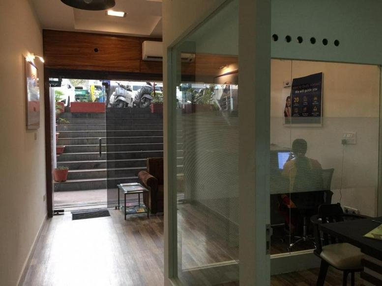 Entrance of RB Tower, Shop LG 005 with glass doors and wood paneling.