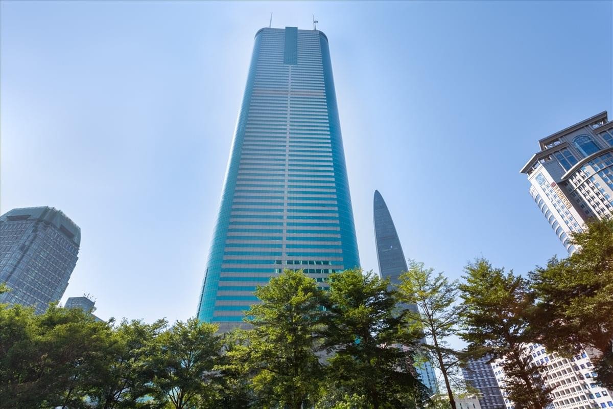 Exterior view of the iconic teal glass skyscraper at Shun Hing Square.