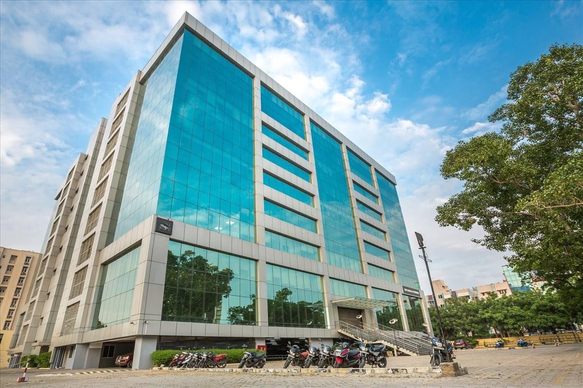 Exterior view of the glass-facade Shyamala Tower building with a modern design.